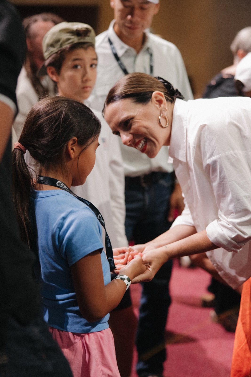 A leader greeting a young girl at an Agape gathering